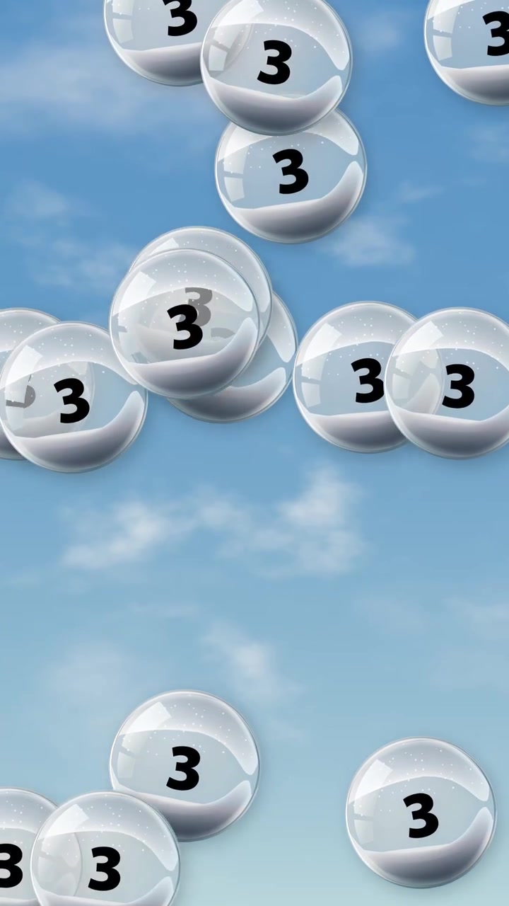 Transparent spheres containing the number three float and bounce against a bright blue sky background.