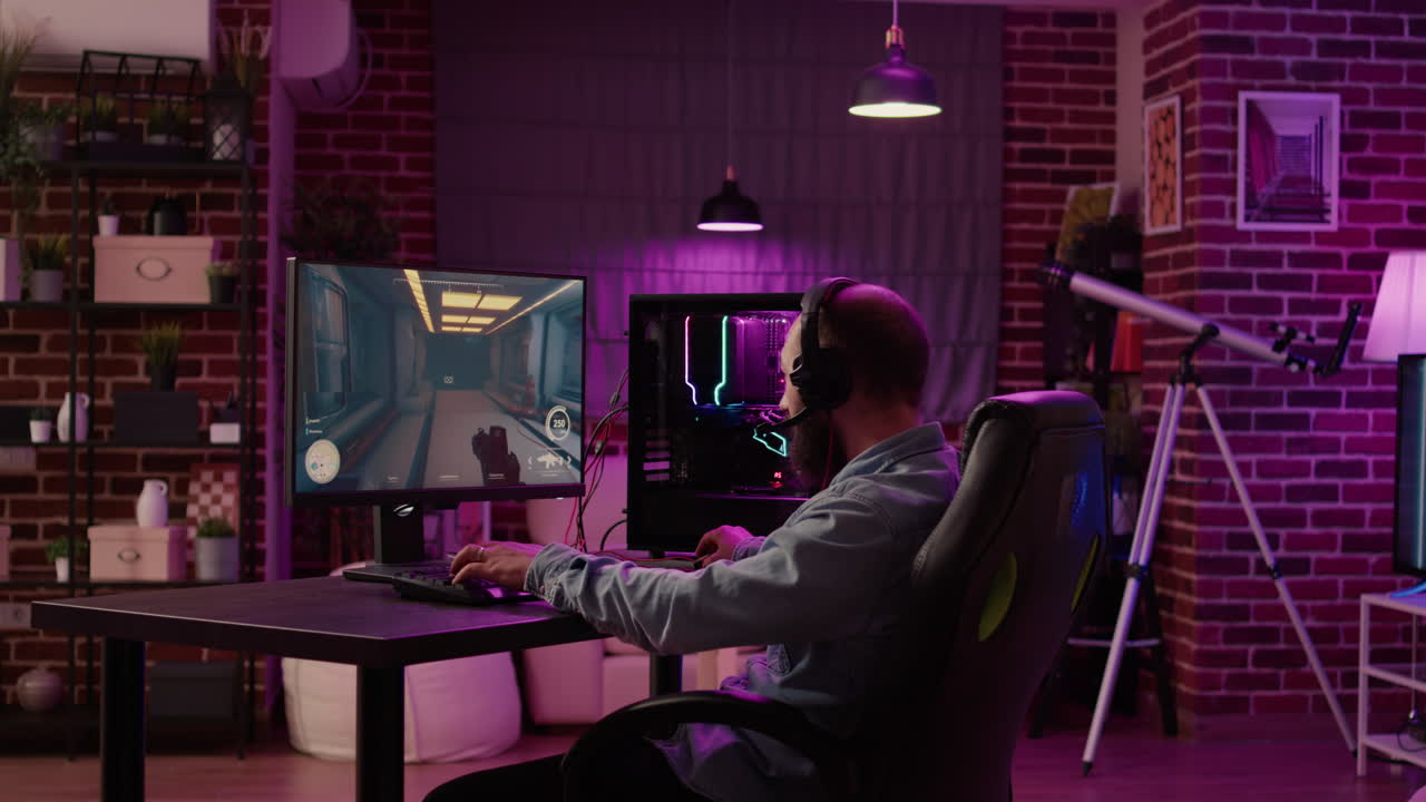 Man using pc gaming setup relaxing playing multiplayer online action game talking to team on headset