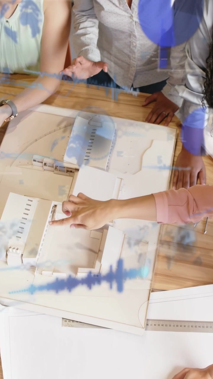 Vertical video: Women pointing then tapping model, showing tablet as blue overlay guiding design