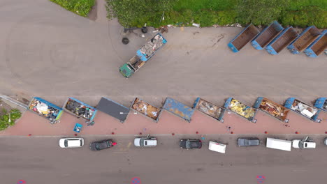 recyclable refuse dumped in different containers at recycling centre, top aerial