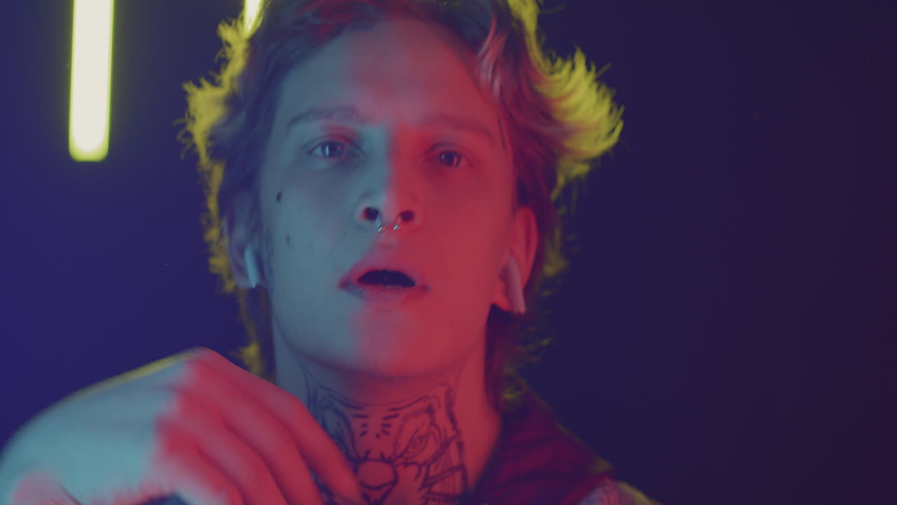 Close-up Portrait of a Person with Tattoos and Piercings