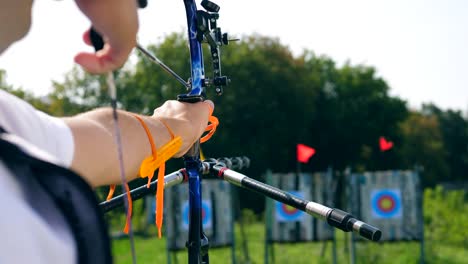 person shoots a bow at a targer.