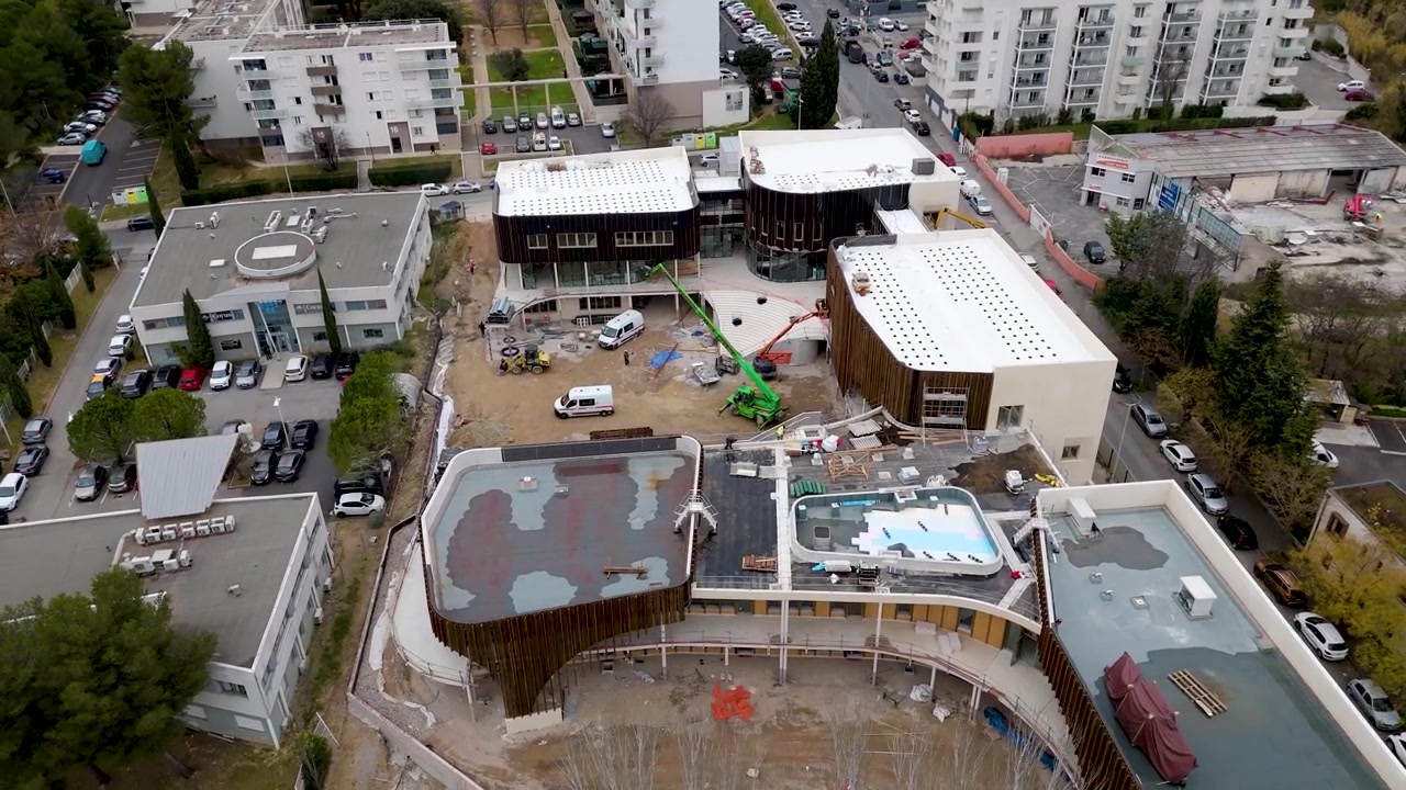 Aerial Drone Orbiting Building Construction Site in Montpellier France Urban Residential Neighborhood and Park