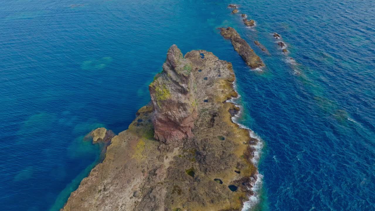 Aerial establishing above famous cliff stone in Japanese sea at Shakotan Hokkaido blue ocean landscape