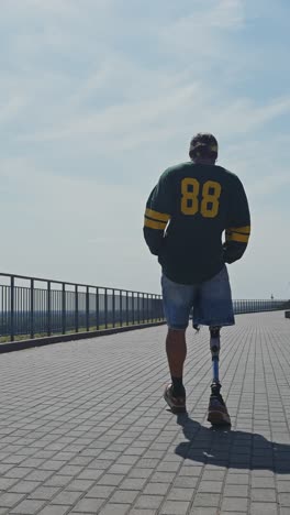 man with prosthetic leg walking outdoors