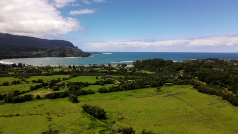 aerial pan of hanalei bay and surrounding land on a clear day