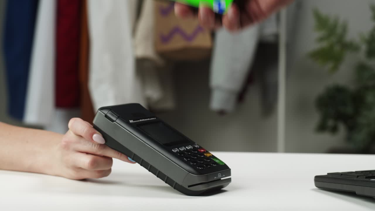 Payment by smartphone with chroma green screen via terminal without entering the PIN code, contactless paying while shopping to observe safety protection, using mobile phone making transaction