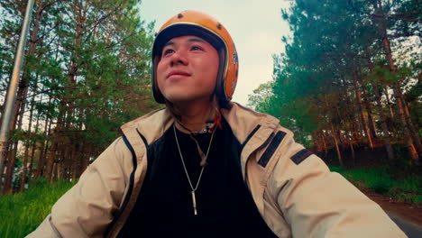 man riding motorcycle in forest