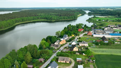 Aerial-of-Tarczyny-village-in-Poland,-showcasing-the-serene-Tarczynskie-Lake