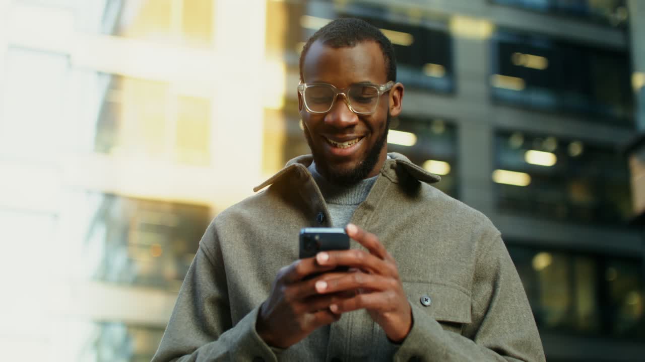 Man using smartphone in a city