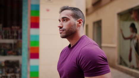 young man walking through commercial street outdoors.