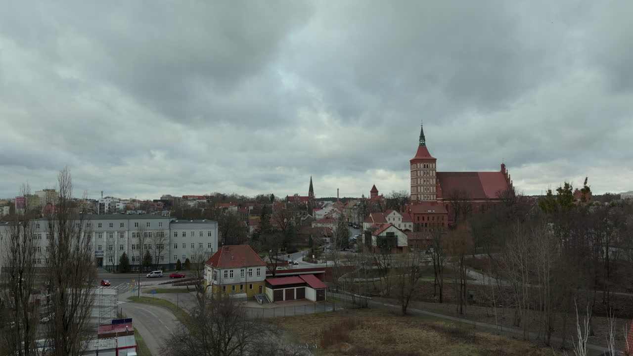 día nublado sobre la ciudad de olsztyn con edificios históricos y la iglesia de san santiago en el fondo
