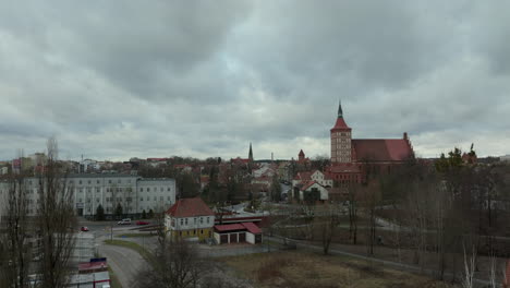 cloudy day over city of olsztyn with historic buildings and st james’s church in background