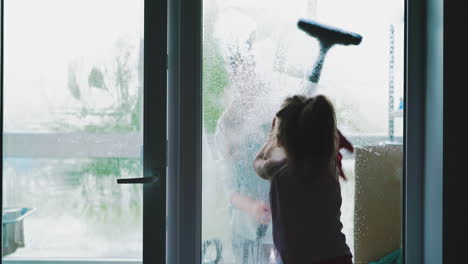 mom washes window from outside