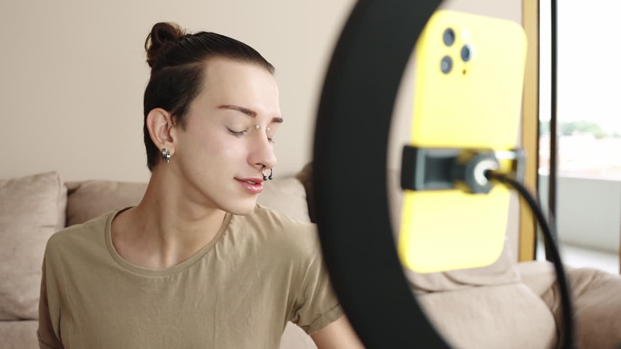 Man recording a makeup tutorial with ring light and smartphone