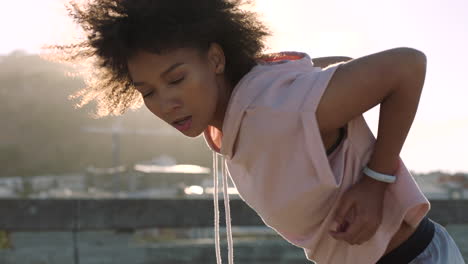 young black woman dancing outdoors