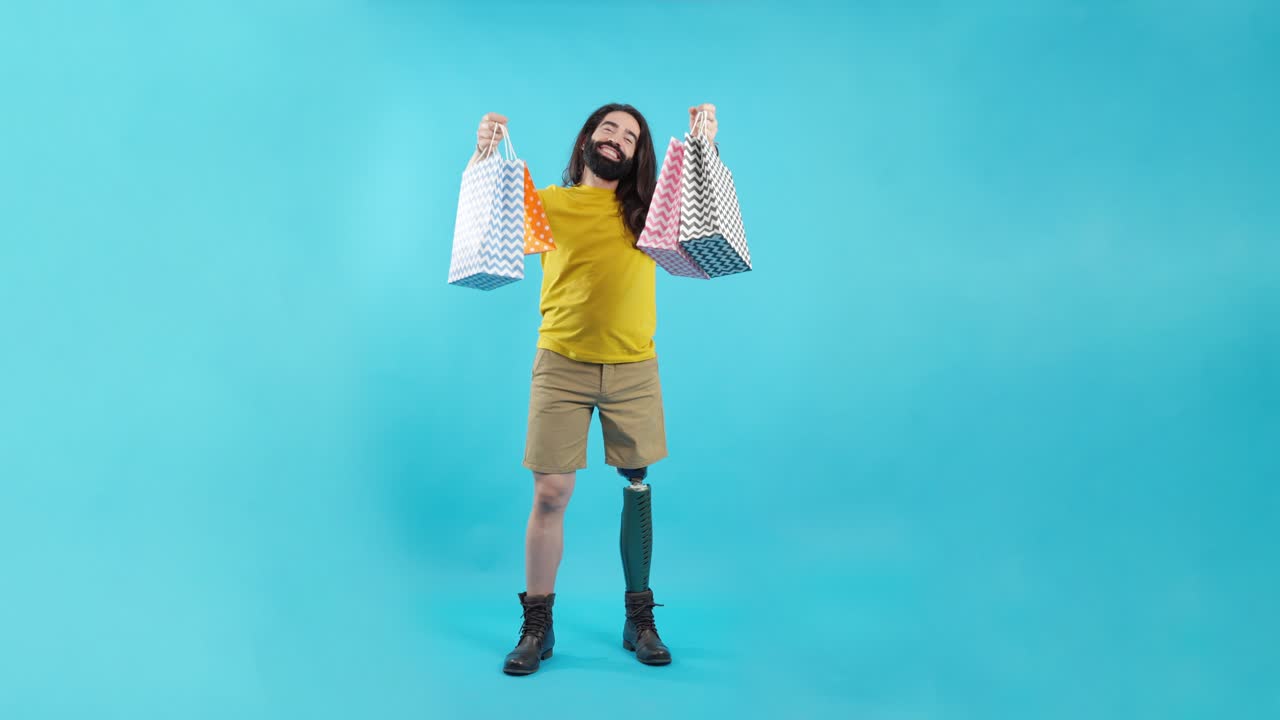 Happy Man with Prosthetic Leg Holding Shopping Bags on Blue Background