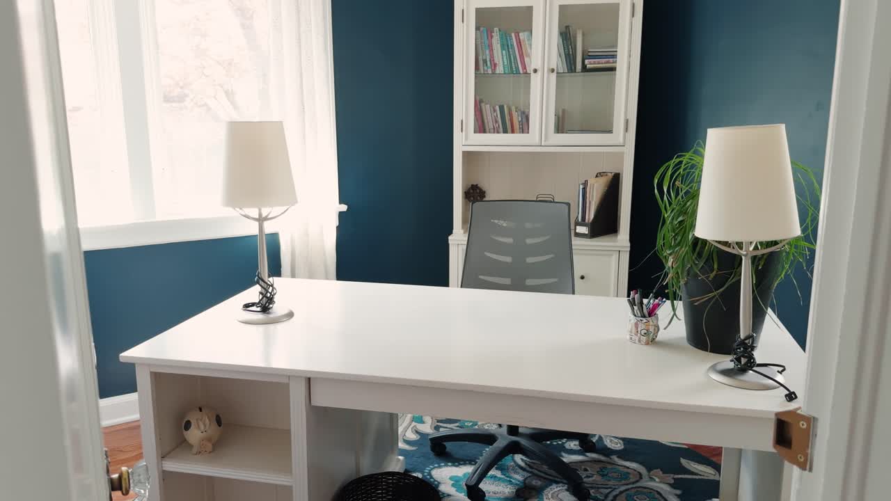 Smooth glide reveals bright home office with desk, chair, and natural light