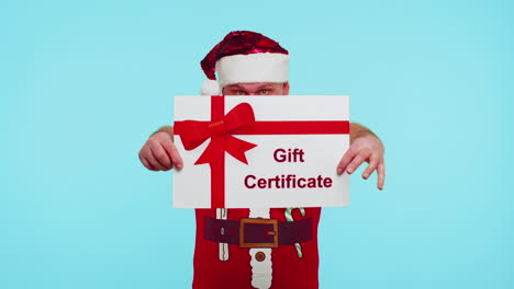 funny man wears red new year t-shirt and hat presenting card gift certificate coupon winner voucher