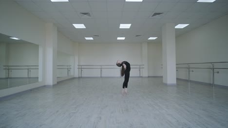 young ballerina practicing dance moves in studio