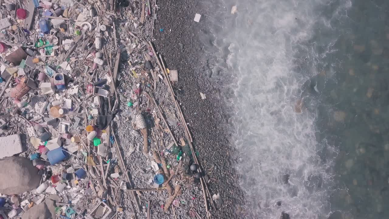 Climate change is impacted by beach covered in plastic and rubbish in Hong Kong. Aerial drone view