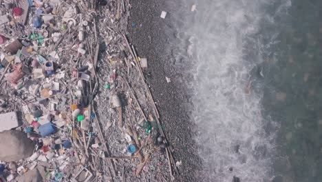 climate change is impacted by beach covered in plastic and rubbish in hong kong. aerial drone view