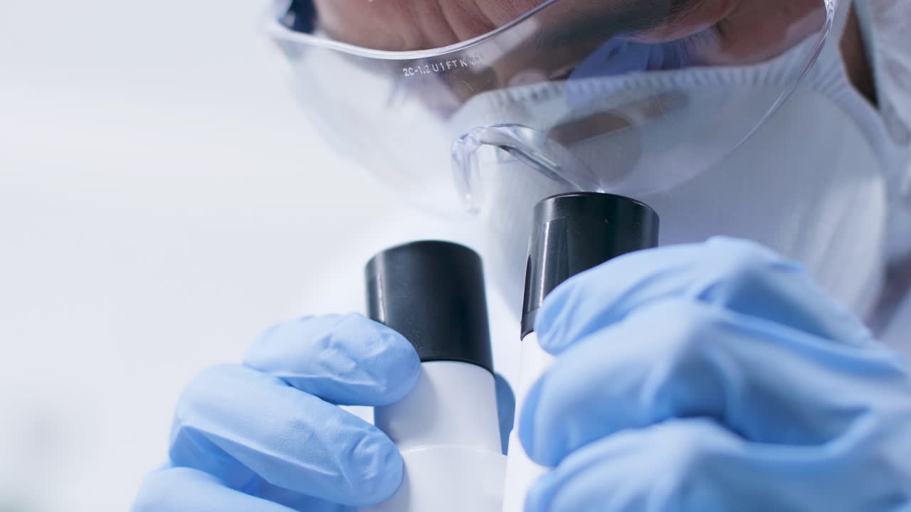 Scientist using a microscope in a lab