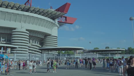 large crowd of people outside san siro stadium in milan, italy