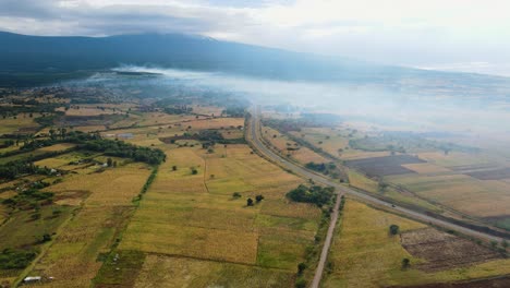 aerial view of a wildfire endangering the countryside of east africa - rising, drone shot