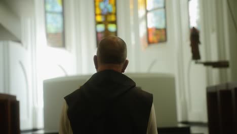 beautiful scene of a monk praying in a church