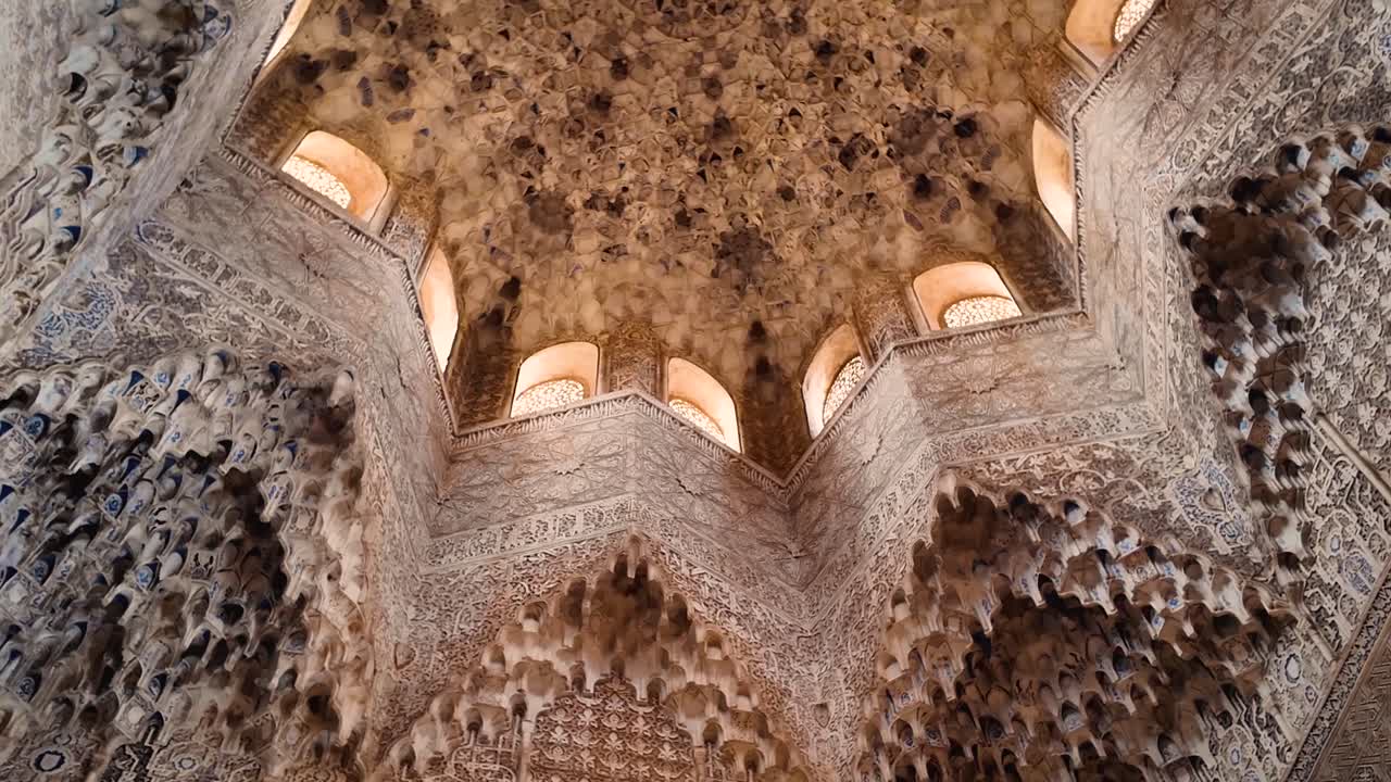 Panoramic shot of the Arab-style details on the walls and ceiling of the Hall of the Two Sisters within the Nasrid Palaces of the monumental Alhambra complex in Granada, Spain