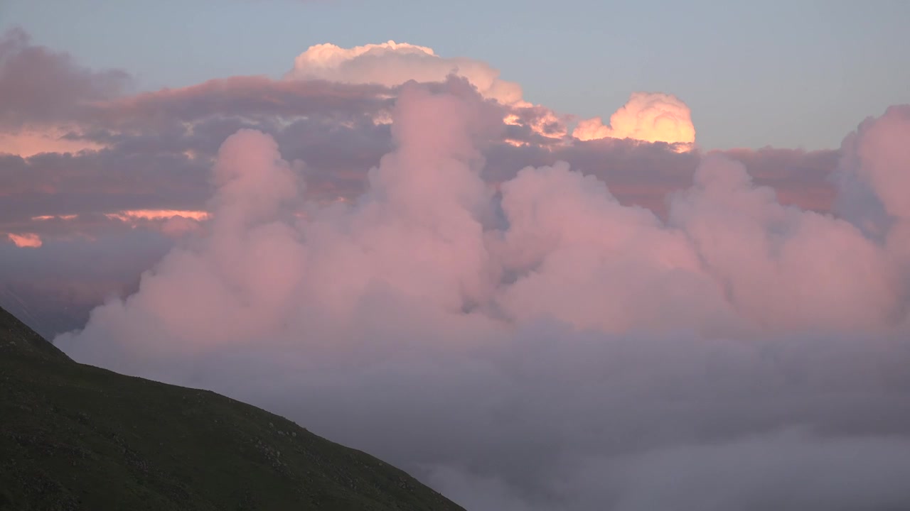 Time Lapse of Clouds Moving Over Mountain Peaks at Sunset