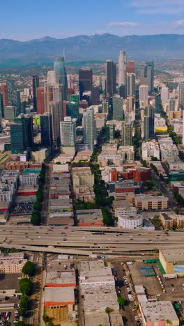 travel aerial view of urban los-angeles buildings. modern city downtown los angeles. vertical video