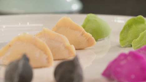 Colorful-dough-dumplings-on-a-plate-in-closeup-handheld-shot