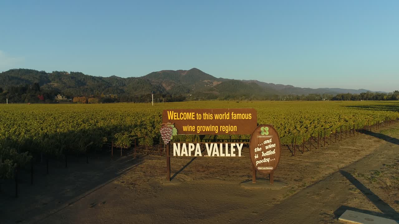 Pan down aerial shot of the welcome to the napa valley sign