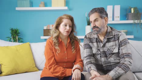 middle-aged couple comforting each other.
