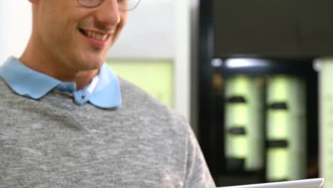 smiling customer using digital tablet in optical store