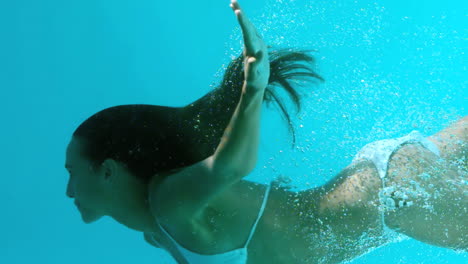 attractive brunette swimming in swimming pool