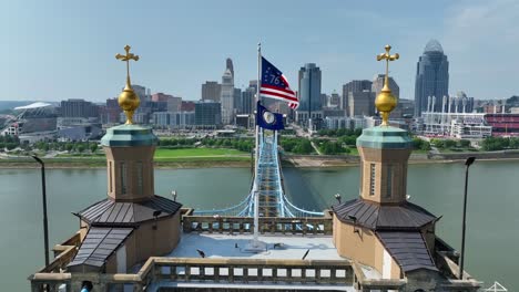 american bennington flag waving on bridge connecting cincinnati, ohio and covington, kentucky over ohio river