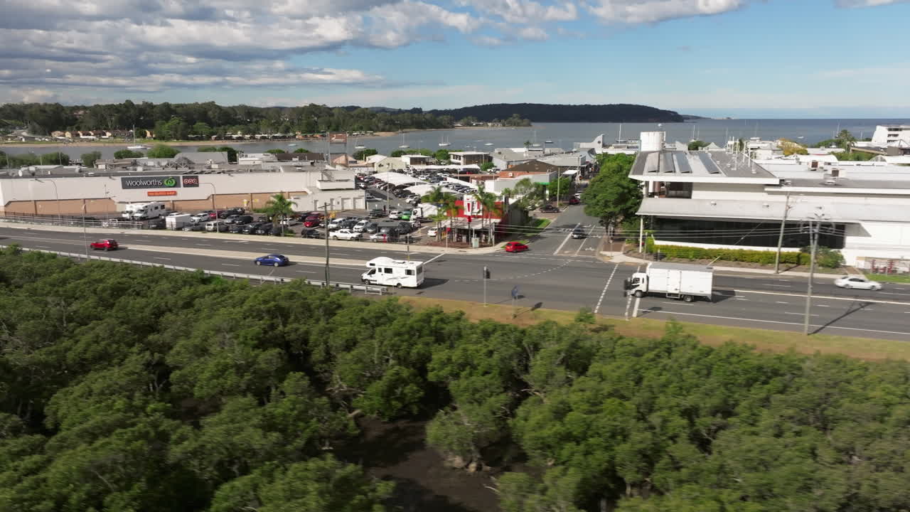 Motorhome driving next to a small town on urban street near Bateman's Bay