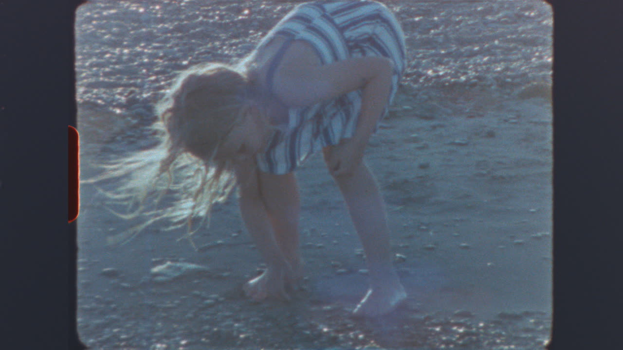 Vintage Film Footage of a Girl Playing on the Beach