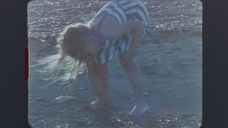 vintage film footage of a girl playing on the beach