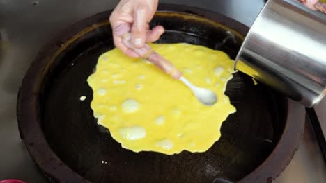 close up slow motion shot of taiwanese pancake with eggs in the making