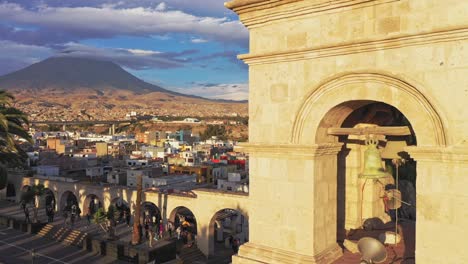 arequipa bell tower and volcano during sunset drone