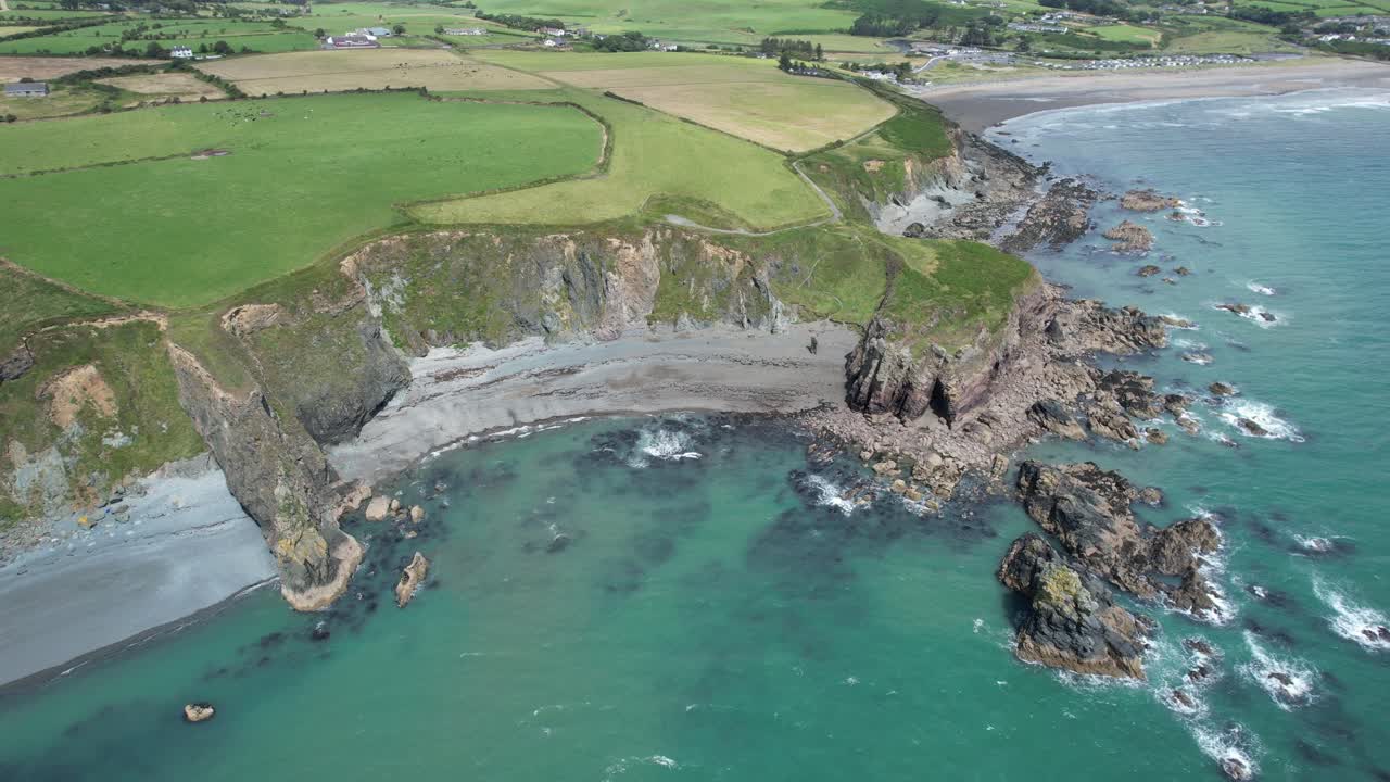 Spectacular view of two popular Waterford beaches Tra Na MBno and Bunmahon on The Copper Coast on a bright summer day