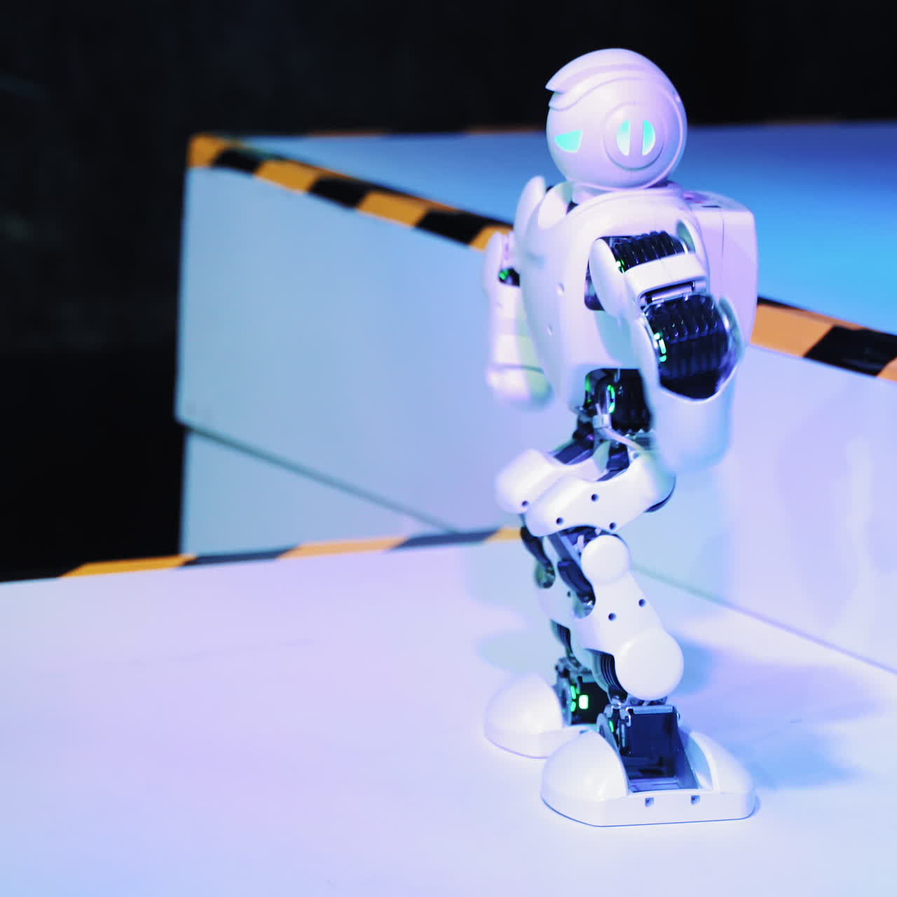 Dancing Robot humanoid. Artificial Intelligence dance at exhibition pavilion showroom. Robotic technology