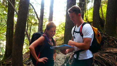 happy hiker couple looking at map