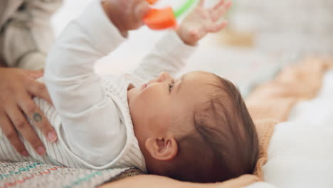 baby child, rattle toys and bed with mother