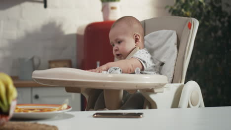 baby eating in high chair