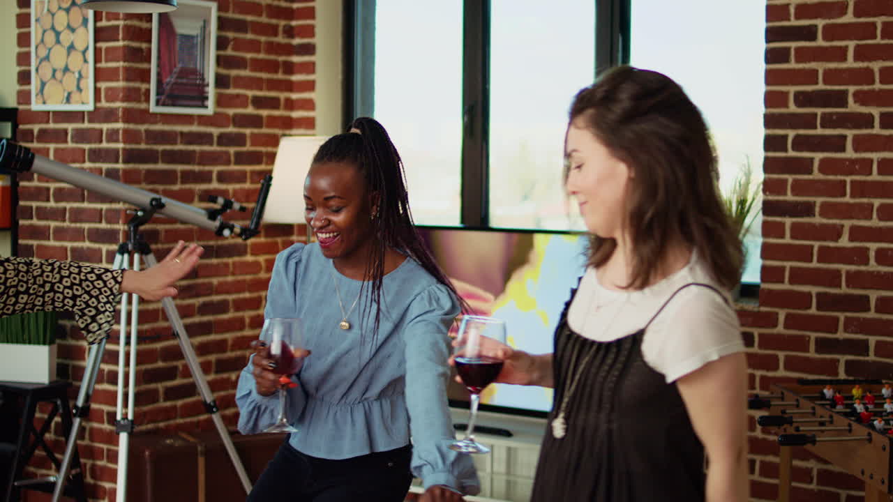 Guests at house party sharing laughter and dance moves, creating vibrant atmosphere in living room